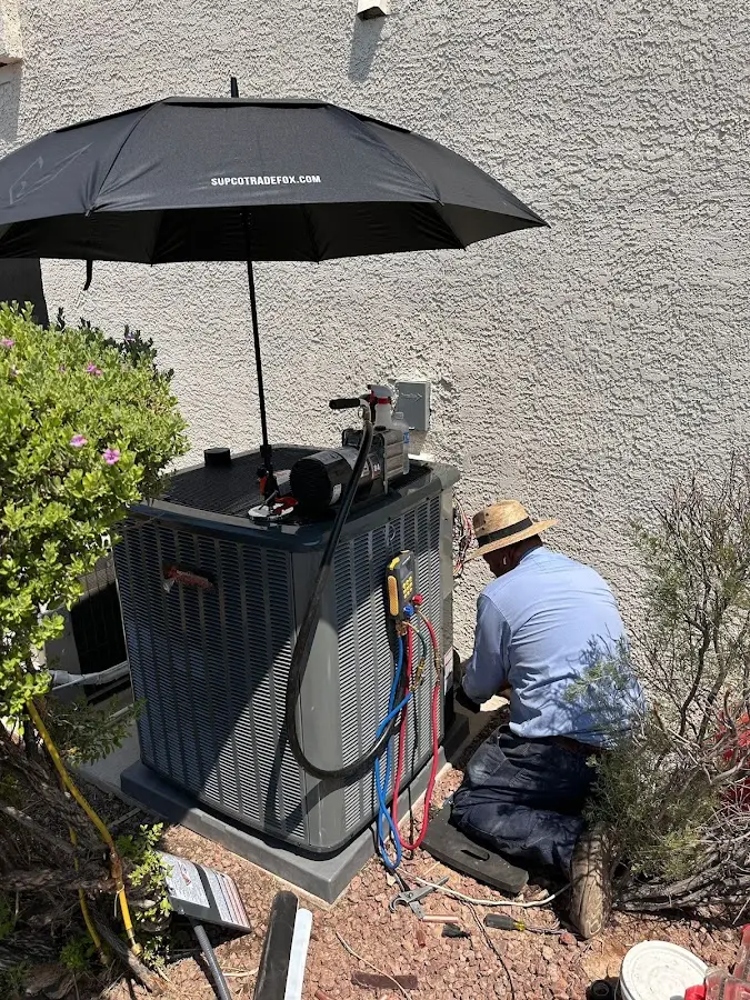 HVAC technician performing outdoor AC maintenance in Honeygo