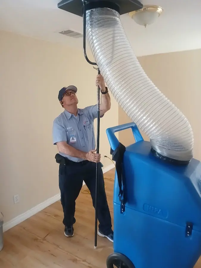 Furnace Tune-Up technician using HEPA equipment in Honeygo
